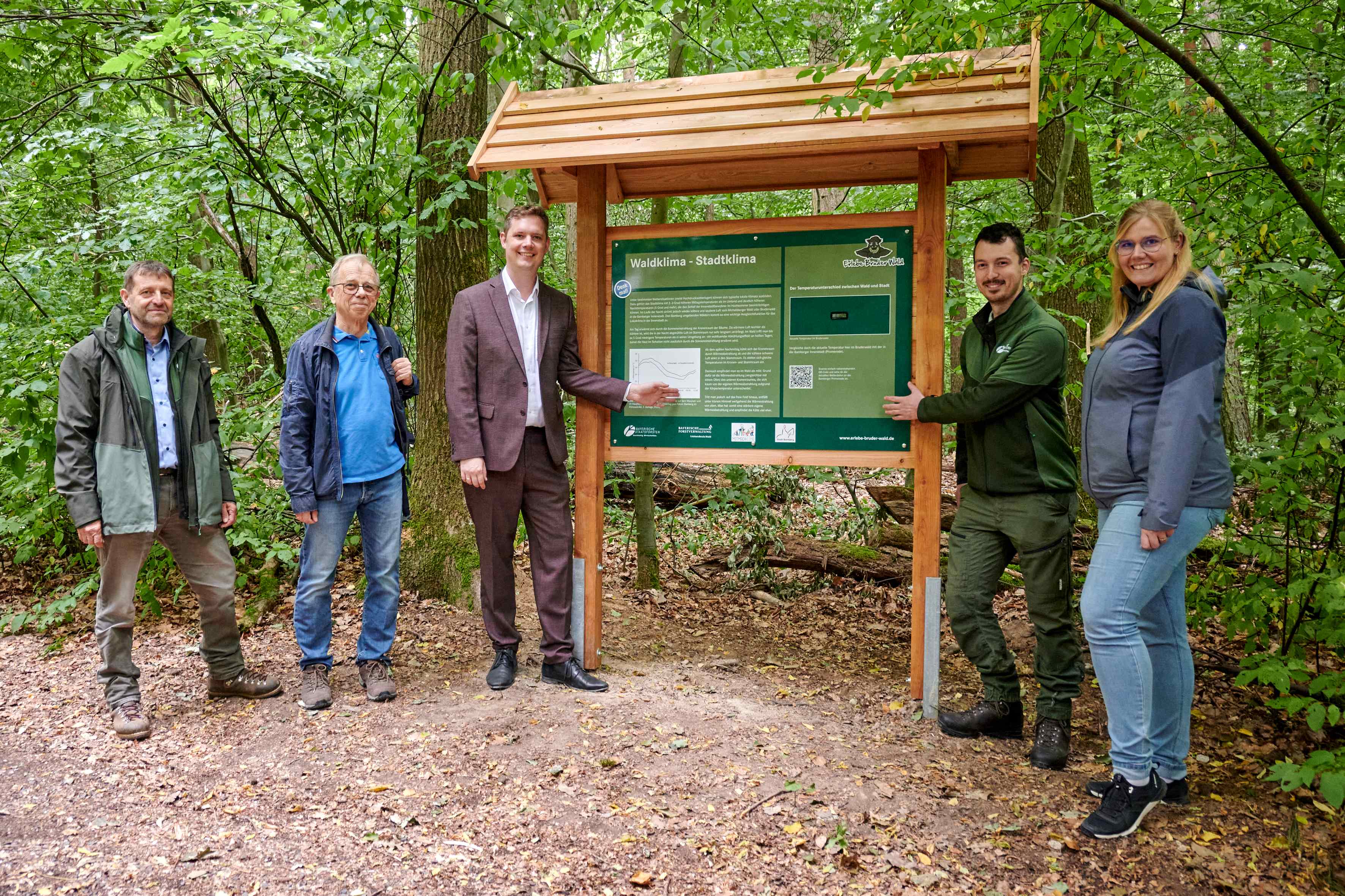 Menschen vor den neuen Tafeln im Wald