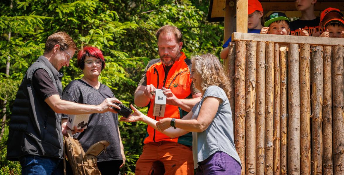 Christian Scheitler von der Firma Steiner-Optik (links) und Christoph Mende bei der Übergabe der Ferngläser an Jana Hanf (rechts) und Sandra Arneth vom Team des Kindergartens Warmensteinach. Und die Kinder sind sichtlich gespannt auf das das Geschenk.